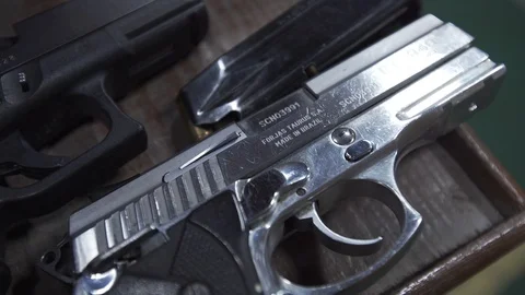 View of unloaded firearms on a table during a gun exhibition Stock Footage 89357922