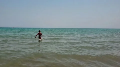 View of an unrecognizable kid in the beach Stock Footage 130739441