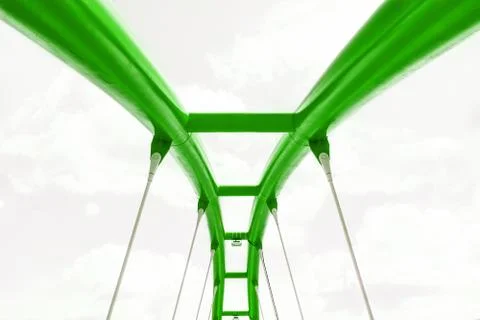 View of the upper structure of the green bridge against the blue sky. Stock Photos