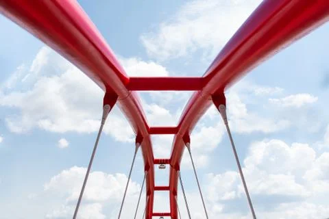 View of the upper structure of the red bridge against the blue sky. Stock Photos