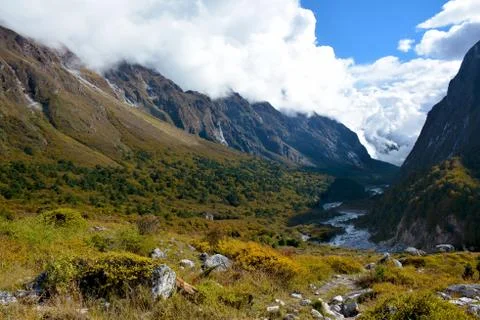 View of the valley covered with clouds on the way from Ghunsa to Lhonak, trek Stock Photos