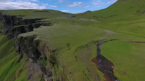 View of the valley with a river and a cliff with a waterfall. Andreev. Stock Footage 78536804