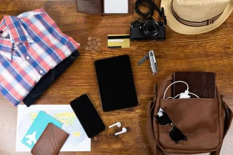 View of a variety of essential travelling items with tablet, smartphone and Stock Photos