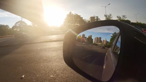 View from a vehicle side mirror capturing the golden hour Stock Footage 345011243