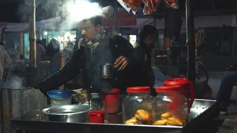 View of a vendor preparing hot tea at a night market, Bangladesh. 스톡 동영상 335550798