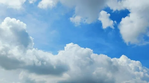 View of a vibrant blue sky adorned with beautiful, fluffy white clouds. 動画素材 311381906
