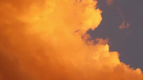 View of vibrant orange clouds drifting gracefully during sunset. Stock Footage 316178828