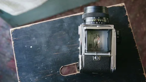 View on video recorder of old moving-film camera of happy multiethnic couple Stock Footage 74364831