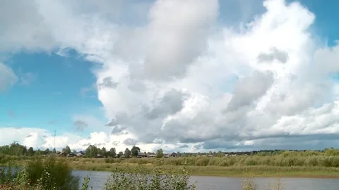 View of the village in summer from across the river Stock Footage 340143959