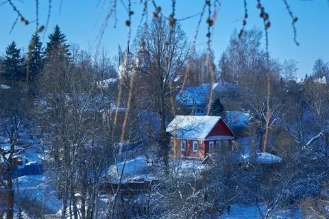 View of village through tree branches in winter Stock Photos