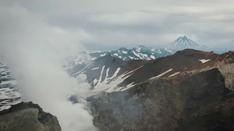 View on Vilyuchinsky Volcano Over the Active Crater of Mutnovsky Volcano Stock Footage 167113536
