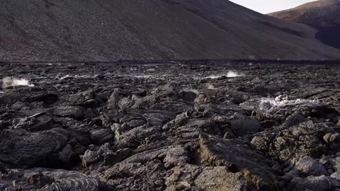 A view of a volcano that is still active and a view of solidified lava Stock Footage 258262362