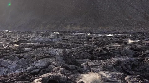 A view of a volcano that is still active and a view of solidified lava Stock Footage 258262384