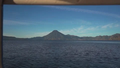 View of the Volcano Through the Window of the Boat on the Lake Stock Footage 293743475