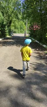 View of a walking child from the back Stock Photos