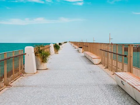 The view of the walking path on the breakwater in the small port Stock Photos