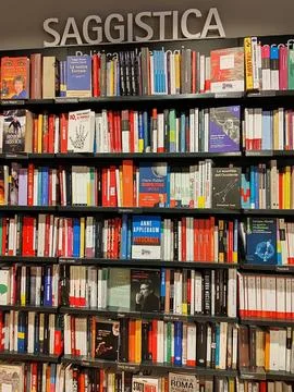 View of a wall-mounted bookcase filled with nonfiction books Stock Photos