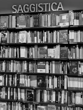 View of a wall-mounted bookcase filled with nonfiction books Stock Photos