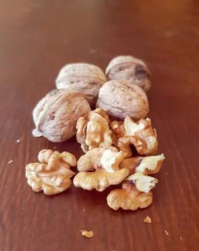 View of walnuts in their shells and without them Stock Photos