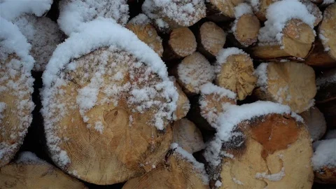 View of the warehouse of firewood in the snowfall slow motion. Stock Footage 84945914