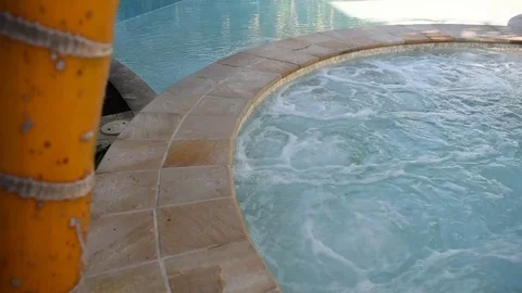 View of warm spa jacuzzi with palm tree Stock Footage 76633925