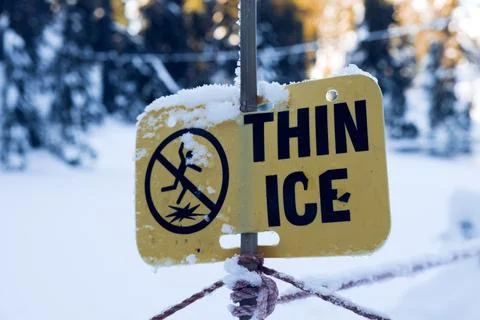 View of warning sign Thin Ice at the Blue Grouse Lake in British Columbia Stock Photos