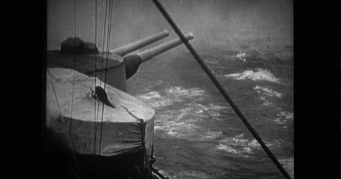 View of warship cannon firing and ship being scuttled Stock Footage