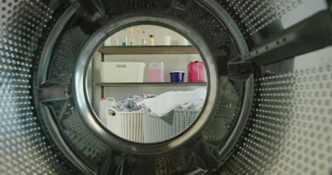 View from the washing machine to rooms with laundry baskets and shelves with Stock Footage 136549677