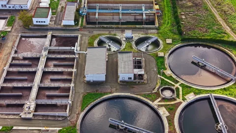 View of a wastewater treatment facility showcasing tanks and processing units on Stock Footage 331261007