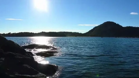 View of water and hill during sunny day at a fjord in Norway near coastal r.. Stock Footage 340195850