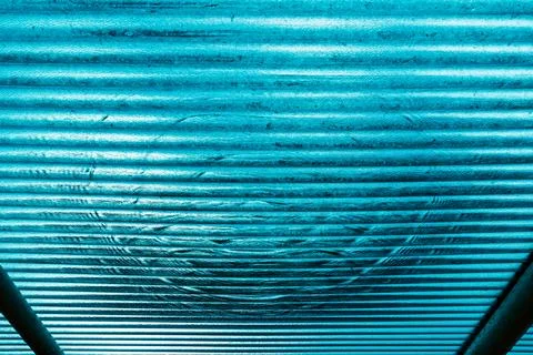View of water drop on translucent or teal blue corrugated plastic roofing s.. Stock Photos