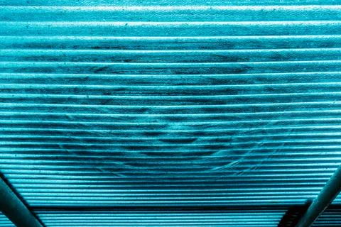 View of water drop on translucent or teal blue corrugated plastic roofing s.. Stock Photos