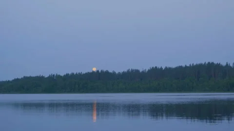 View from water to full moon reflected in lake Vídeo Stock 93734235