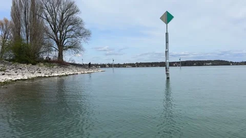 View from water on Lake Constance with Konstanz shoreline and mountains Stock Footage 333337121