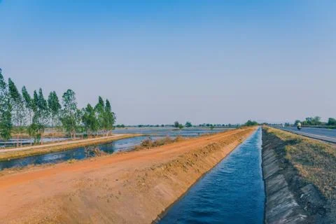 View of Water management in the rice fields from the irrigation canal before  Stock Photos