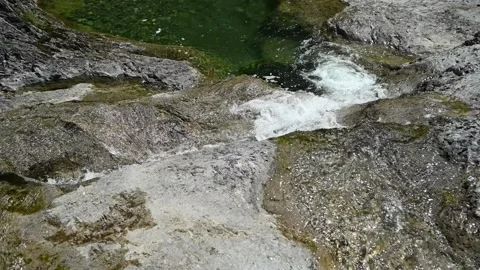 A view of water from a mountain stream running over rocks (slow motion) Stock-Footage 219637804