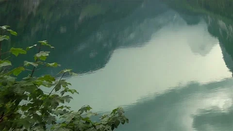 View in water reflection of Alpine Landscape lake surrounded by mountains Stock Footage 121464814