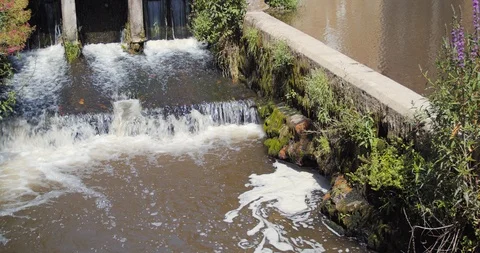 View of water from a small lock flowing from the moat of the castle in Fougères Stock Footage 112094461