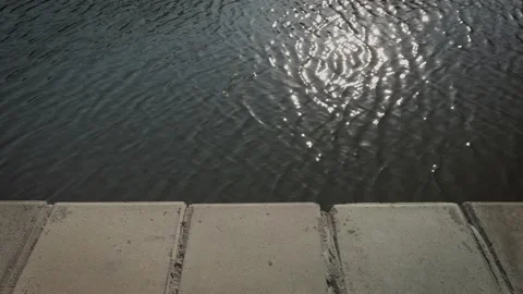 View at the water with small waves over the concrete parapet Video stock 146010654