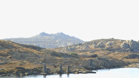 View from the water of some of the ancient ruins of the island of Delos Stock Footage 108596333