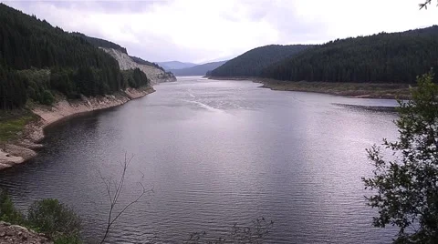 View of a water storage dam. On both sides of the water, you can see  Stock Footage 59938567