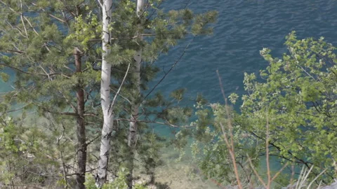 View of the water surface of a mountain lake in sunny weather. Background. Stock-Footage 112640885