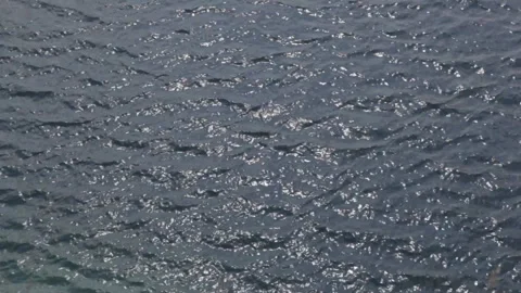 View of the water surface of a mountain lake in sunny weather. Background. Stock Footage 112641384