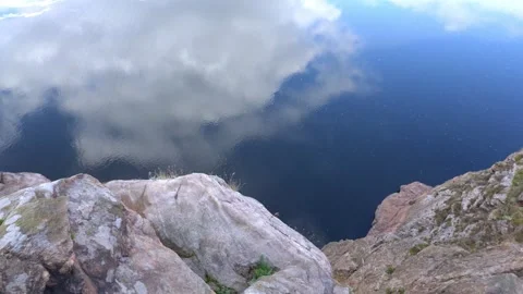 View on water from the top of cliff, clouds reflection on surface. Video stock 321150999