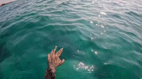 A view of water waves with hands moving like swimming at Ad Dimaniyat Islands Stock Footage 295076147
