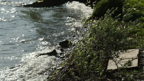 View on water waves on sun rays at sunset and Strong wind Video stock 131111731