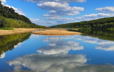 View of the water in which is reflected the blue sky Stock Photos