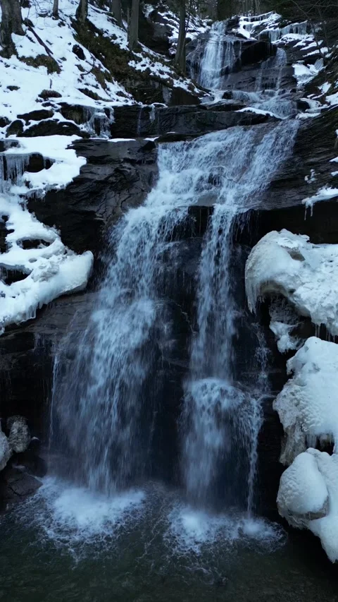 View of a waterfall during winter. Cold and frost in the forest Stock Footage 275853900