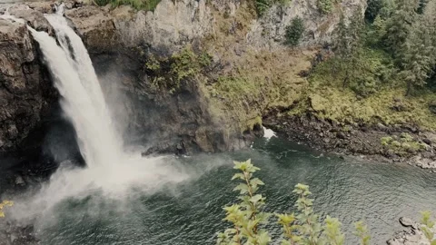 View of waterfall flowing into river. Shooting from bottom to top Vidéo 323772454