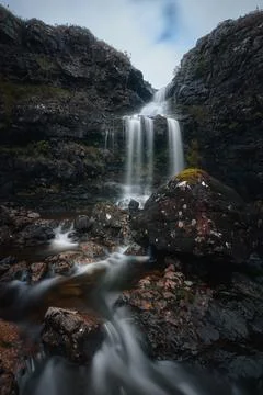 View of a waterfall on a mountain stream Stock Photos